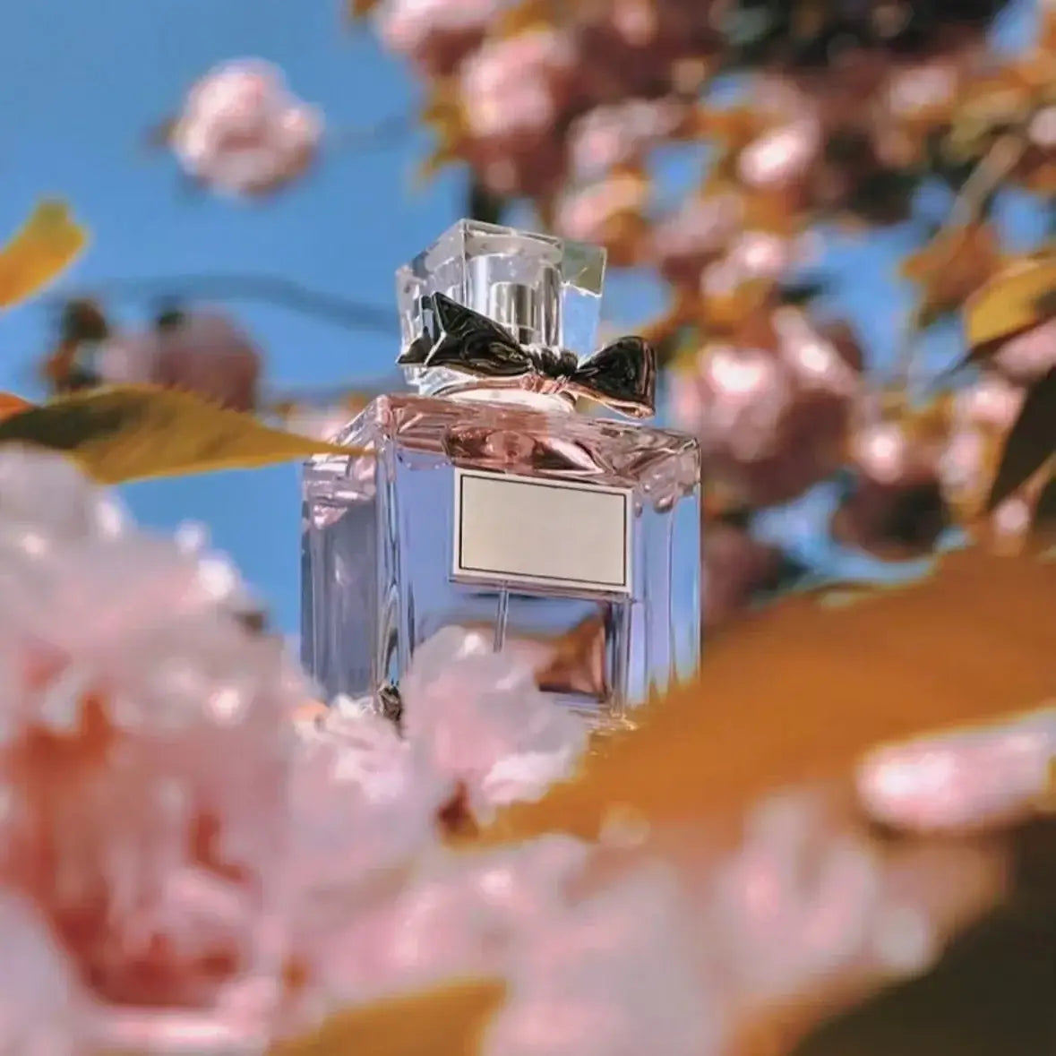 Women's Floral Body Spray 100ml - Long-Lasting Romantic Perfume with cherry blossoms in the background.