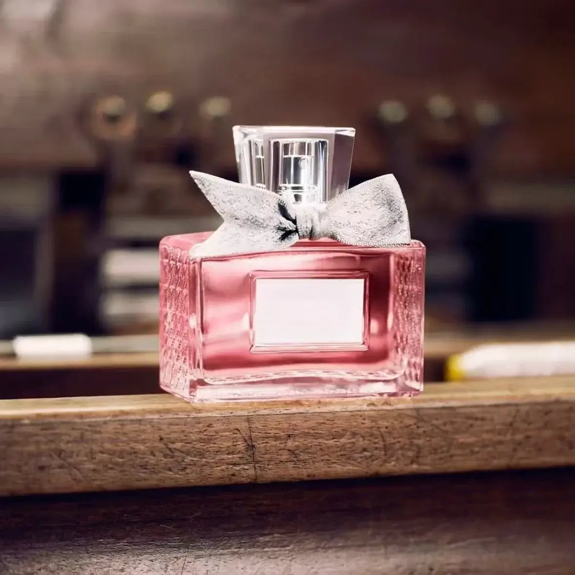 Women's Floral Body Spray 100ml - Long-Lasting Romantic Perfume in an elegant pink bottle with a bow.