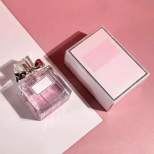 Women's Floral Body Spray 100ml - Long-Lasting Romantic Perfume displayed with its box on a pink background.