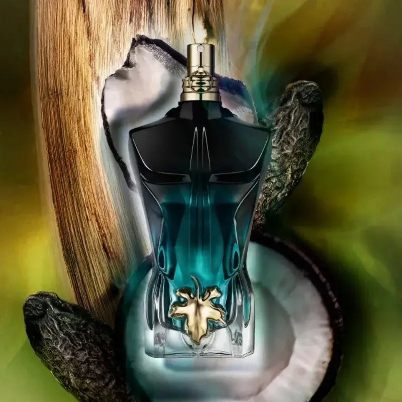 Jean Paul Gaultier Le Beau Eau de Parfum bottle with coconut and wood background.