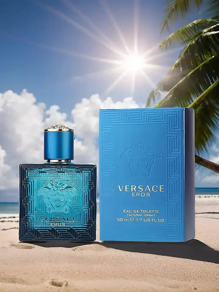 Versace Eros Eau de Toilette 100ml200ml bottle and box on sandy beach with sunlight and palm trees.