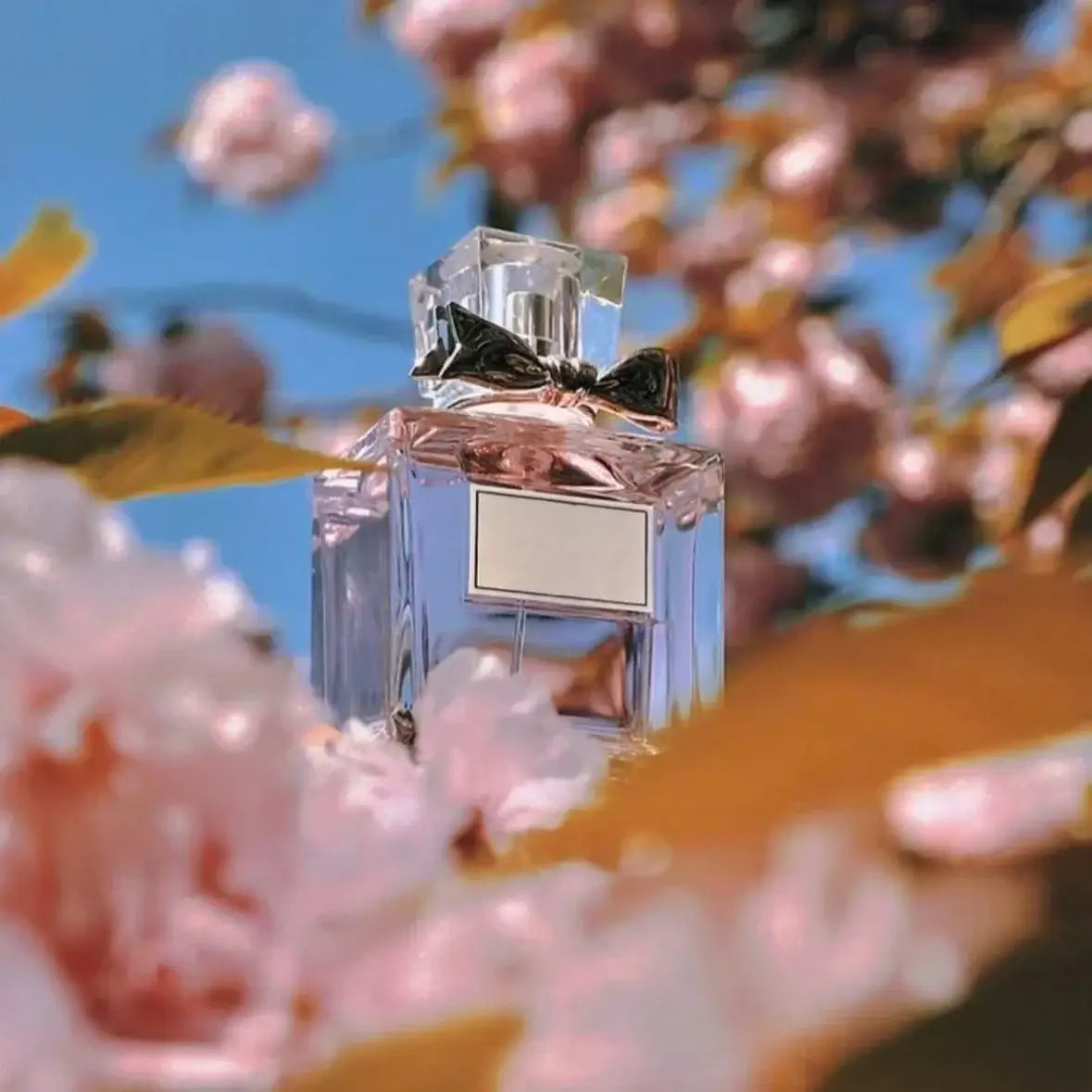 Women's Floral Body Spray 100ml - Long-Lasting Romantic Perfume bottle surrounded by blooming flowers.