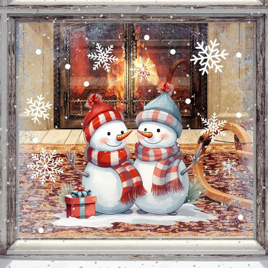 Two snowmen with scarves in front of a fireplace with snowflakes around.