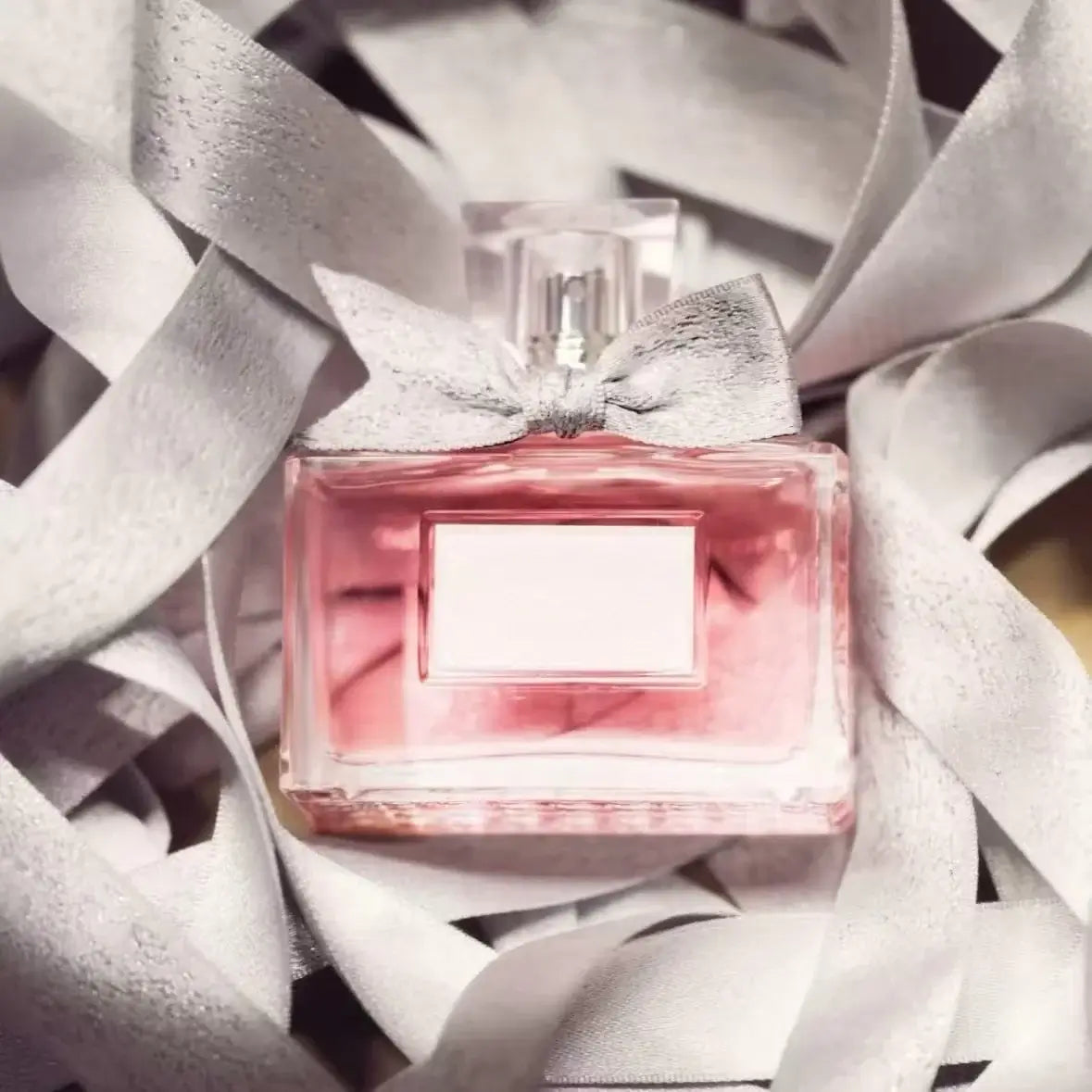 Women's Floral Body Spray 100ml - Long-Lasting Romantic Perfume in elegant bottle surrounded by ribbons.