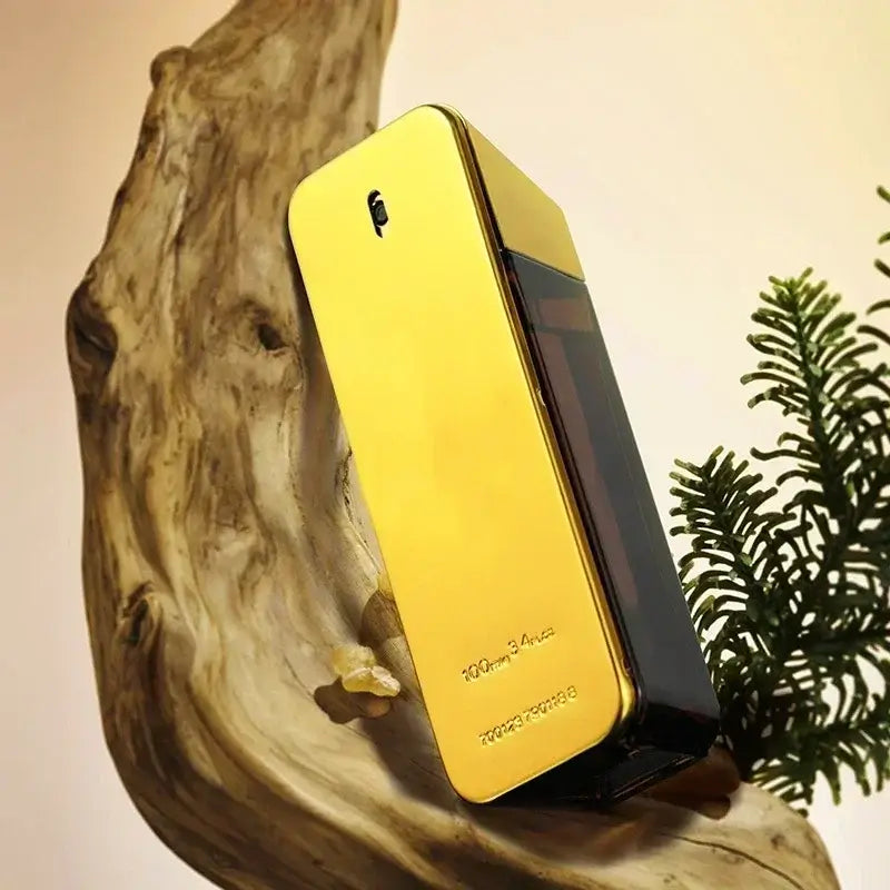 luxury men's eau de parfum bottle displayed on natural wood with greenery in background