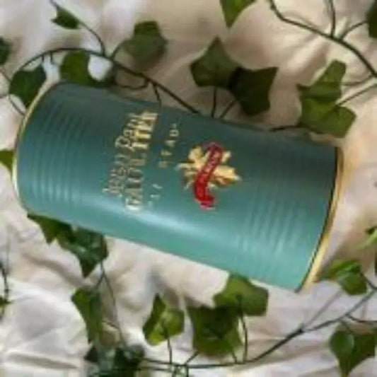 Jean Paul Gaultier Le Beau Eau de Parfum 125ml bottle displayed on a soft surface with greenery.